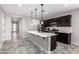 Modern kitchen with dark wood cabinets, white countertops and stainless steel appliances at 17657 W Buckhorn Trl, Surprise, AZ 85387