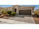 Contemporary home with a two-car garage and neatly landscaped yard at 17657 W Buckhorn Trl, Surprise, AZ 85387