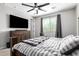 Spacious bedroom with large TV, dresser, and comfortable bed at 17657 W Buckhorn Trl, Surprise, AZ 85387