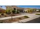 Single-story home with two-car garage and well-manicured landscaping at 17657 W Buckhorn Trl, Surprise, AZ 85387