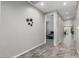 Modern hallway with tile floors and views into other rooms at 17657 W Buckhorn Trl, Surprise, AZ 85387