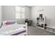 Charming bedroom with a twin bed and built in shelving at 17657 W Buckhorn Trl, Surprise, AZ 85387