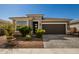 Modern single story home with two car garage and well manicured landscaping at 17657 W Buckhorn Trl, Surprise, AZ 85387