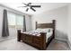 Spacious bedroom with large windows, neutral walls and wood bed frame at 17657 W Buckhorn Trl, Surprise, AZ 85387
