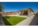 Backyard with covered patio and artificial turf at 17657 W Buckhorn Trl, Surprise, AZ 85387