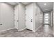 Neutral-toned hallway with tile flooring and access to rooms at 17657 W Buckhorn Trl, Surprise, AZ 85387
