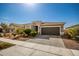 Gray single-story house with a two-car garage and drought-tolerant landscaping at 17657 W Buckhorn Trl, Surprise, AZ 85387