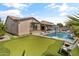 Landscaped backyard with putting green and spacious patio at 21487 E Arroyo Verde Dr, Queen Creek, AZ 85142