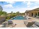 Stunning pool area with a pergola, comfortable seating, and a basketball hoop at 21487 E Arroyo Verde Dr, Queen Creek, AZ 85142