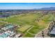 Aerial view of a golf course with pools and a residential area nearby at 17245 W Dartmouth St, Surprise, AZ 85388