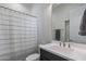 Clean bathroom with dark vanity, shower, and white striped curtain at 17245 W Dartmouth St, Surprise, AZ 85388