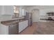 Bright kitchen with stainless steel appliances and white cabinets at 40752 W Robbins Dr, Maricopa, AZ 85138
