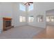 Open concept living area with fireplace and high ceilings at 40752 W Robbins Dr, Maricopa, AZ 85138