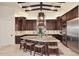 Large kitchen with granite countertops, dark wood cabinets and island with seating at 4455 E Quail Brush Rd, Cave Creek, AZ 85331