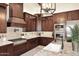 Gourmet kitchen featuring dark wood cabinetry, granite countertops, and stainless steel appliances at 4455 E Quail Brush Rd, Cave Creek, AZ 85331