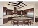 Gourmet kitchen with dark wood cabinets and granite island at 4455 E Quail Brush Rd, Cave Creek, AZ 85331