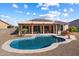 Inviting kidney-shaped pool with a large patio area at 18195 W Redwood Ln, Goodyear, AZ 85338