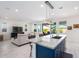Modern kitchen with large island, white cabinetry, and blue tile backsplash at 12075 N San Clemente St, Surprise, AZ 85388