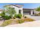 Single-story home with a two-car garage and landscaped yard at 12075 N San Clemente St, Surprise, AZ 85388