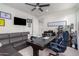 Functional home office with a large desk and comfortable sectional sofa at 12075 N San Clemente St, Surprise, AZ 85388