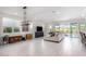 Bright living room with large sectional sofa, sliding glass doors to backyard, and modern light fixture at 12075 N San Clemente St, Surprise, AZ 85388