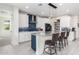 Modern kitchen with white cabinets, blue tile backsplash and large island at 12075 N San Clemente St, Surprise, AZ 85388