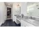 Modern bathroom with double sinks, large mirrors, and hexagon tile floor at 12075 N San Clemente St, Surprise, AZ 85388