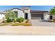 Single-story home with a two-car garage and landscaped yard at 12075 N San Clemente St, Surprise, AZ 85388