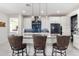 Modern kitchen features white cabinets, blue tile backsplash, and breakfast bar at 12075 N San Clemente St, Surprise, AZ 85388