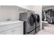 Convenient laundry room with washer, dryer, and utility sink at 12075 N San Clemente St, Surprise, AZ 85388