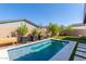 Inviting pool area with a grassy lawn and stone walkways at 12075 N San Clemente St, Surprise, AZ 85388
