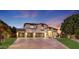 Two-story home with three-car garage and manicured lawn at 13110 W Denton St, Litchfield Park, AZ 85340