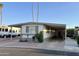 Single-wide manufactured home with carport and landscaped yard at 11411 N 91St Ave # 217, Peoria, AZ 85345