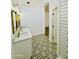 Elegant bathroom boasts dual sinks, gold fixtures, and patterned tile floor at 5984 W Geronimo Ct, Chandler, AZ 85226