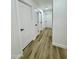 Long hallway with three doors and light brown vinyl plank flooring at 5984 W Geronimo Ct, Chandler, AZ 85226