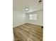 Spacious bedroom with light wood flooring and large window at 5984 W Geronimo Ct, Chandler, AZ 85226