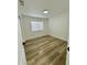 Bright bedroom with light wood flooring and a window with blinds at 5984 W Geronimo Ct, Chandler, AZ 85226