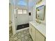 Elegant bathroom with a walk-in shower, double vanity, and patterned tile floor at 5984 W Geronimo Ct, Chandler, AZ 85226