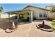 Spacious backyard with covered patio, brick pavers, and mature landscaping at 5984 W Geronimo Ct, Chandler, AZ 85226