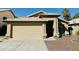 Single story house with tan exterior and two car garage at 5984 W Geronimo Ct, Chandler, AZ 85226