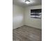 Simple bedroom with wood-look floors and window coverings at 11411 N 91St Ave # 217, Peoria, AZ 85345