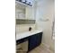 Bathroom with navy vanity, white countertop, and updated fixtures at 11411 N 91St Ave # 217, Peoria, AZ 85345