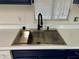 Stainless steel kitchen sink with a wooden drainer at 11411 N 91St Ave # 217, Peoria, AZ 85345