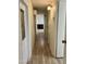 Long hallway with light walls and wood-look flooring at 11411 N 91St Ave # 217, Peoria, AZ 85345