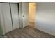 Bedroom with wood-look floors and a large closet at 11411 N 91St Ave # 217, Peoria, AZ 85345