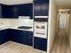Hallway with wood-look flooring and access to bedrooms at 11411 N 91St Ave # 217, Peoria, AZ 85345