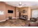 Living room with two brown sofas, a TV, and tile flooring at 8714 W Heber Rd, Tolleson, AZ 85353