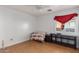Simple bedroom with tile floor and window with red curtains at 8714 W Heber Rd, Tolleson, AZ 85353