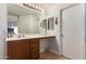 Clean bathroom with a vanity, mirror, and access to a closet at 8714 W Heber Rd, Tolleson, AZ 85353