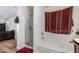 Bathroom with shower, bathtub, and a view into the bedroom at 8714 W Heber Rd, Tolleson, AZ 85353